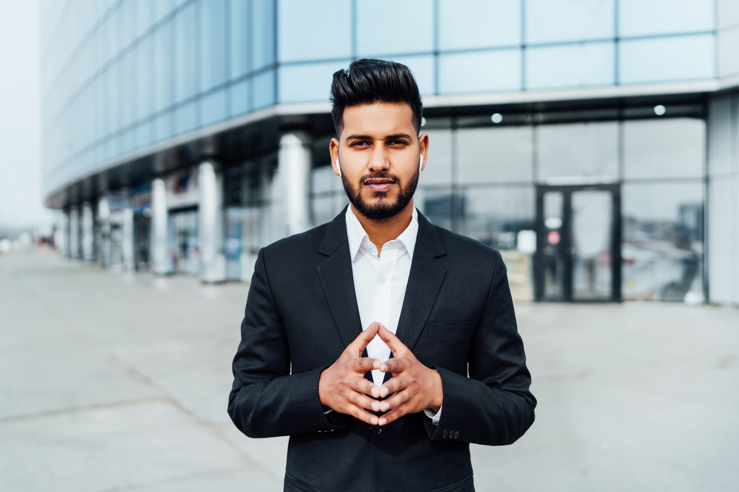 portrait serious smiling modern indian man near office building 1 scaled